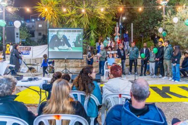 Haifa, Israel - December 05, 2024: Family of the hostage Matan Angrest, with player of Maccabi Haifa FC, and Dr. Daniela Mazor, in an assembly of support of the hostages, Haifa, Israel clipart