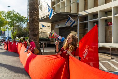 Haifa, Israel - December 11, 2024: Women activist group Bonot Alternativa protest near the Rabbinical Court, against the plan to extend these courts authorities. Haifa, Israel clipart