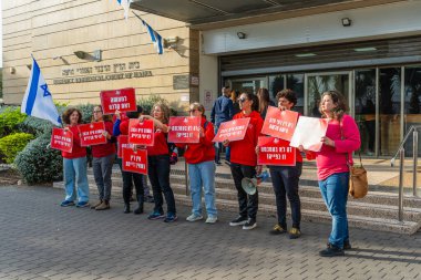 Haifa, Israel - December 11, 2024: Women activist group Bonot Alternativa protest near the Rabbinical Court, against the plan to extend these courts authorities. Haifa, Israel clipart