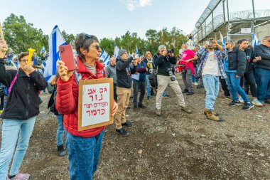 Kishon, Israel - December 20, 2024: People are protesting near the Kishon detention center in support of activist arrested after firing Naval Flares. Kishon, Israel clipart