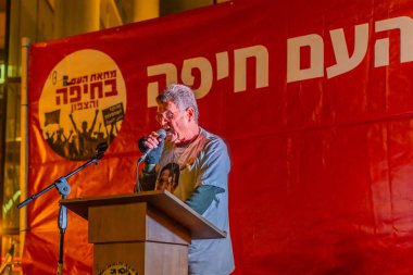 Haifa, Israel - December 21, 2024: Yaakov Godo speaks to the crowd, part of a protest rally against the government. Haifa, Israel clipart