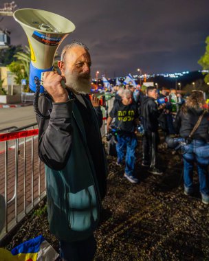 Kishon, Israel - December 23, 2024: People are protesting near the Kishon detention center in support of activist arrested after firing Naval Flares. Kishon, Israel clipart