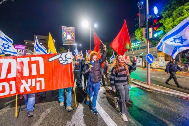 Hayfa, İsrail - 28 Aralık 2024: İnsanlar (Hashomer Hatzair gençlik hareketi ile birlikte) çeşitli tabelalar ve bayraklarla bir protesto yürüyüşüne katılarak yeni seçimler ve bir rehine anlaşması çağrısında bulundular. Hayfa, İsrail