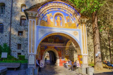 Rila, Bulgaria - October 07, 2023: View of the entrance gate of the Rila Monastery (Monastery of Saint John of Rila), with visitors. Bulgaria clipart