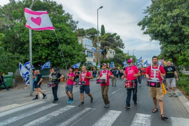 Hayfa, İsrail - 10 Mayıs 2025: İnsanlar savaşın sona ermesi, rehine anlaşmasının tamamlanması ve yeni seçimler çağrısında bulunan bir protesto yürüyüşüne (Pembe Cephe Grubu) katılıyor. Hayfa, İsrail
