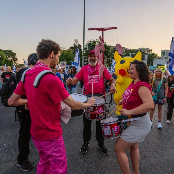 Hayfa, İsrail - 24 Mayıs 2025: Bateri çemberi, Pikachu kostümlü bir adam, savaşın sona ermesi, rehine anlaşmasının tamamlanması ve yeni seçimler için düzenlenen protesto mitinginin bir parçası. Hayfa, İsrail