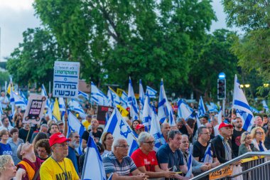 Hayfa, İsrail - 7 Haziran 2025: Çeşitli tabela ve bayraklara sahip bir kalabalık, savaşın sona ermesi, rehine anlaşmasının tamamlanması ve yeni seçimler için düzenlenen protesto mitingine katıldı. Hayfa, İsrail