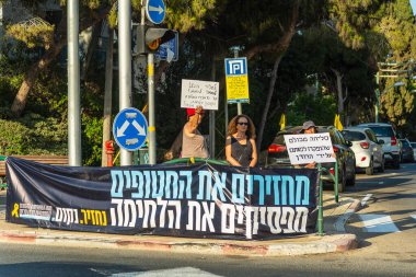 Hayfa, İsrail - 07 Ağustos 2025: İnsanlar kırmızı çizgideki gece protestolarına katılarak, hükümeti savaşı uzatmamaya ve rehine anlaşmasının tamamlanmasına çağırdılar. Hayfa, İsrail