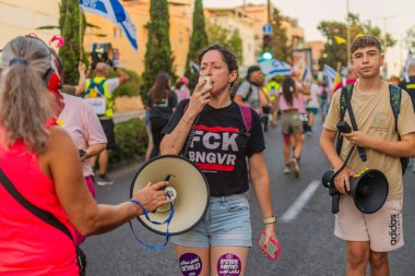 Hayfa, İsrail - 30 Ağustos 2025: Çeşitli tabela ve bayraklara sahip insanlar savaşın sona ermesi, rehine anlaşmasının tamamlanması ve yeni seçimler için düzenlenen protesto mitingine katıldılar. Hayfa, İsrail