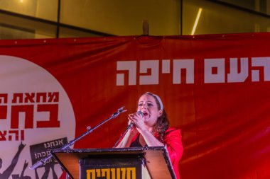 Hayfa, İsrail - 30 Ağustos 2025: Şarkıcı Mor Rosenfeld, savaşı bitirme, rehine anlaşmasının tamamlanması ve yeni seçimler çağrısında bulunan bir protesto mitinginde kalabalığa şarkı söyledi. Hayfa, İsrail