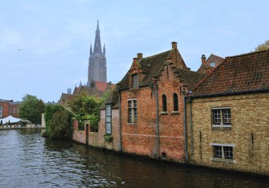 30-10-2014 Bruges, Belçika - Bruges ikonik evleri, katedrali ve kanalı gösteren panoramik bir manzara, mimari cazibesini sergiliyor