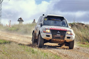 09-11-2014 Trijueque, Spain - A vehicle speeds through Trijueque during the 2014 Rally TT Guadalajara clipart