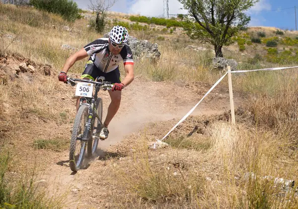 stock image 03-08-2014 Brihuega, Spain - Cyclist slides downhill on dry, hot day at MTB race in Brihuega