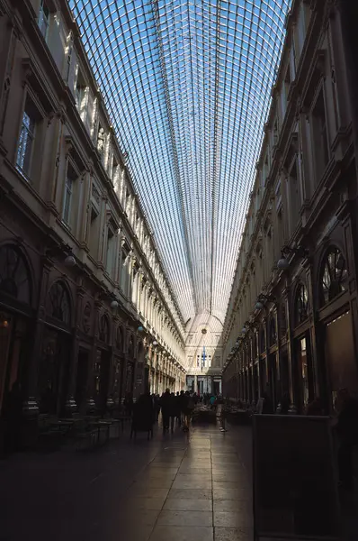 stock image 28-10-2014 Brussels, Belgium - People stroll under the striking contrast of shadow and light in this iconic arcade, Saint Hubert Royal Gallery.