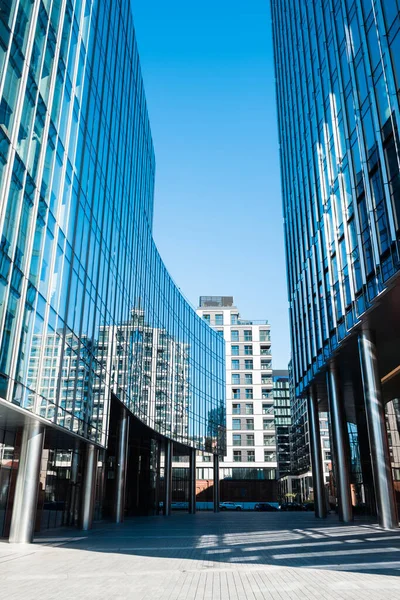 stock image Walkway between modern glass buildings with metal columns.