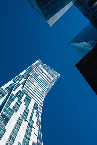 Skyscrapers on the background of the blue sky. Bottom view.