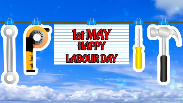 hanging first may labour day with labour tools on blur sky background.
