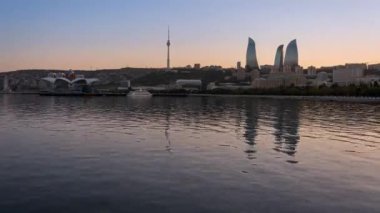Day to Night Timelapse of the skyline in Baku, Azerbaijan with Flame Towers and Baku TV Tower in the background