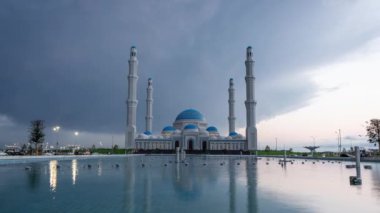 Kazakistan 'daki Astana Büyük Camii' nin zaman aşımı bir gölete yansıyor.