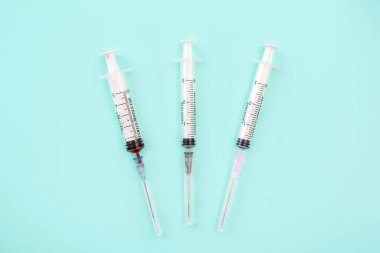 Syringe and needles on color background