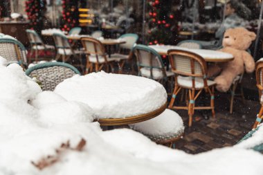 tables in cafes covered with snow