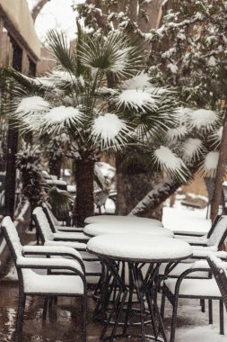 tables in cafes covered with snow
