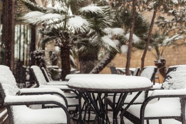 tables in cafes covered with snow