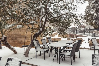 tables in cafes covered with snow