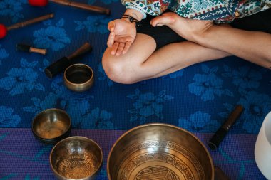 Hand close up The girl is meditating Tibetan singing bowl in sou