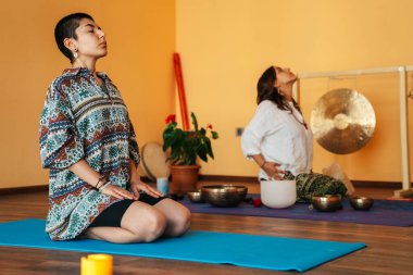 girls on a yoga class. Girls doing yoga and breathing practices 