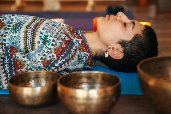 stock image side view The girl is meditating Tibetan singing bowl in sound t