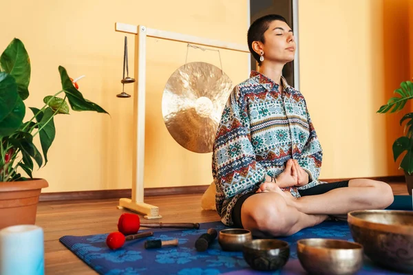 The girl is meditating Tibetan singing bowl in sound therapy