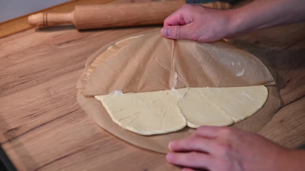 Man Detaches Parchment Paper Rolled Dough — Stock Video