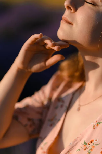 Close-up portrait of a woman in a lavender field