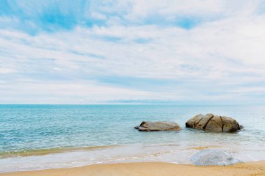 Sea beach with ocean, clouds and Blue sky Summer, Nature landscape view of beautiful tropical sand beach and rock stones.Sunny day Seasacpe 