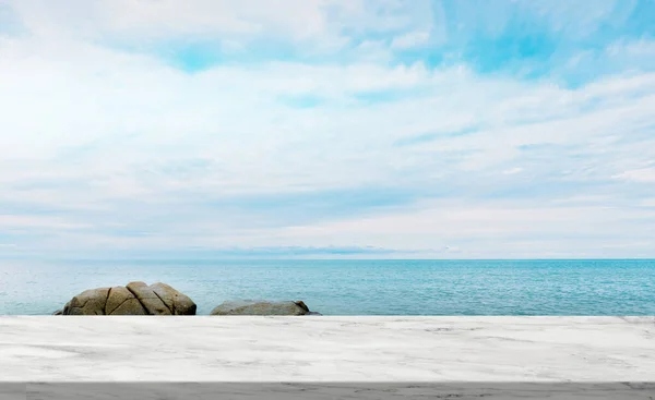Marble texture table top over Sea Beach Ocean with Cloud and Blue Sky,Display Glossy Marble floor on Tropical Sea Beach,Rock stone, Backdrop background with copy space for Summer Product Presentation