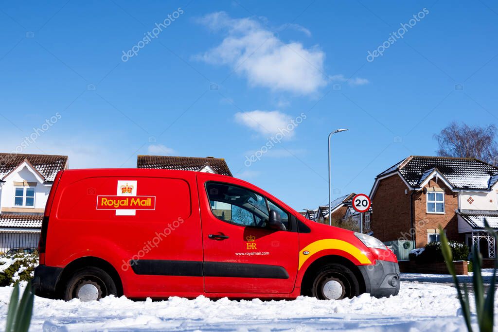 Middlesbrough, United Kingdom - March 10 2023,Royal Mail Car with snow covering on the on the road against clear blue sky on sunny day Winter,British Mail Delivery Van