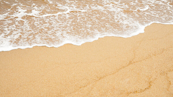 Sea beach and ocean soft wave form on Sand Texture surface, Seaside view of Brown Beach sand dune in sunny day Summer, Horizontal top view for Summer banner background.