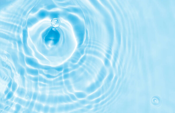 Water texture surface with drop,ripples,splash,Aqua Blue background banner transparent of water waves in sunlight with copy space,Top view Backdrop for Winter Cosmetic,Moisturiser water micellar toner