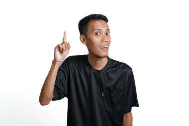 Asian man wearing black training t-shirt, Gesture thinking or getting idea. Isolated by white background