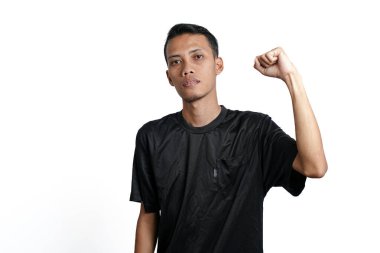 asian man wearing black training t-shirt, showing a strong stance with raised arms and muscles. Isolated by white background