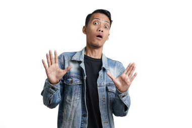 asian man wearing blue jean jacket with excited surprised gesture, isolated on white background