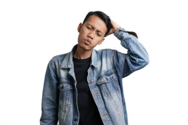 Asian man wearing blue jean jacket has headache or dizzy head. Isolated by white background