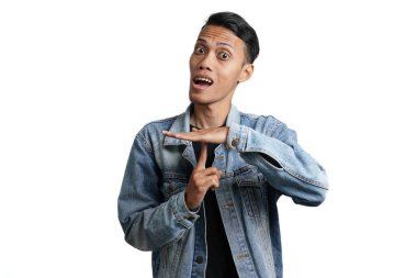 Asian man wearing blue jean jacket gesturing silence, don't make noise. Isolated by white background