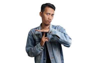 Asian man wearing blue jean jacket gesturing silence, don't make noise. Isolated by white background
