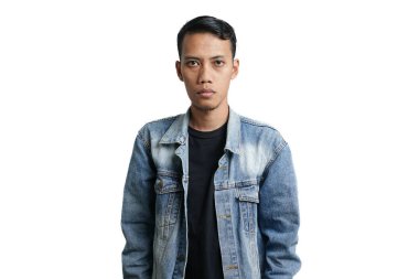 Asian man wearing a blue jean jacket poses cool, quirky like a model. Isolated by white background