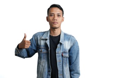 asian man wearing blue jean jacket showing thumbs up, isolated on white background