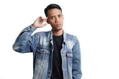asian man wearing blue jean jacket showing expression thinking looking for idea, isolated on white background