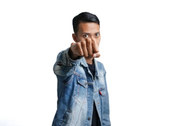 Asian man wearing stylish blue jean jacket while punching style facing you. Isolated by white background