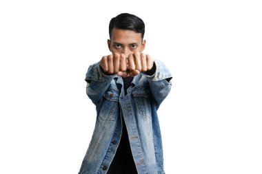 Asian man wearing stylish blue jean jacket while punching style facing you. Isolated by white background